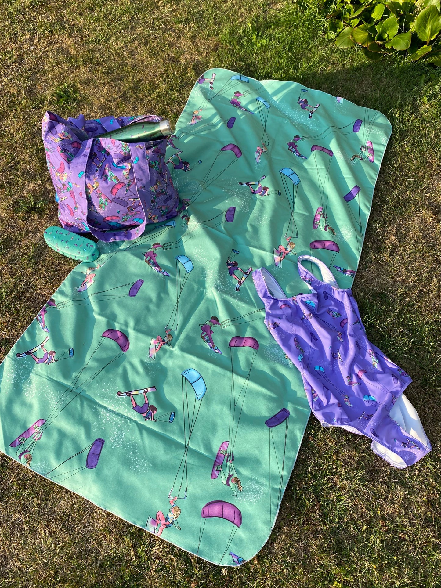 Microfibre towel, swimsuit, c=glasses case, tote bag, bottle.