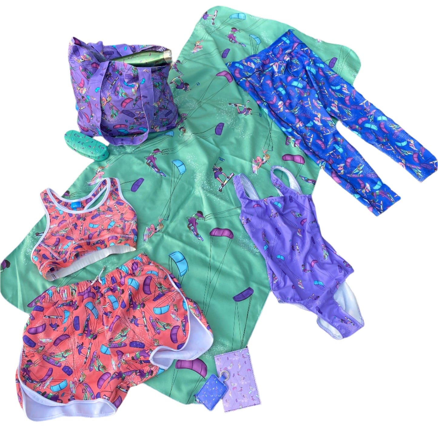 Purple swimsuit with collection of Bellis Kitesurfer products
