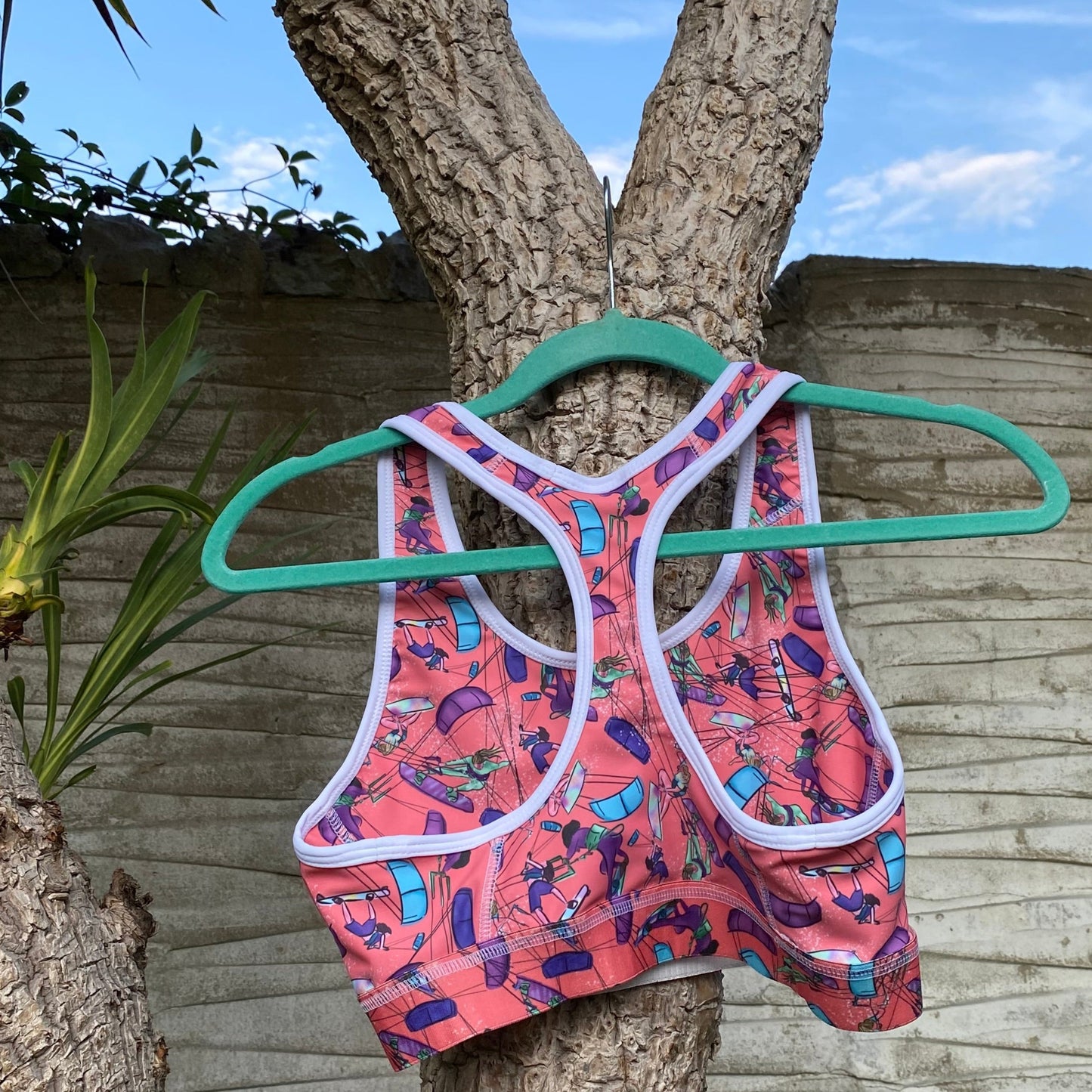 Orange sports bra on hanger