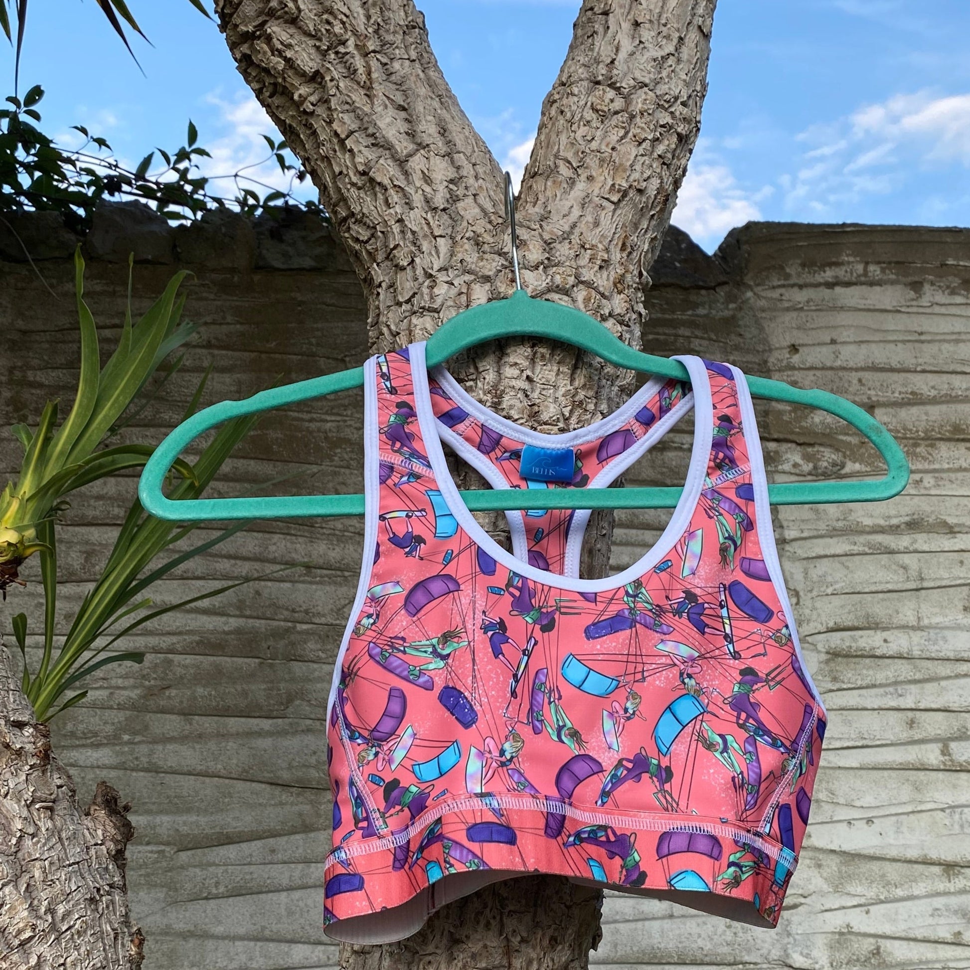 Orange sports bra on hanger