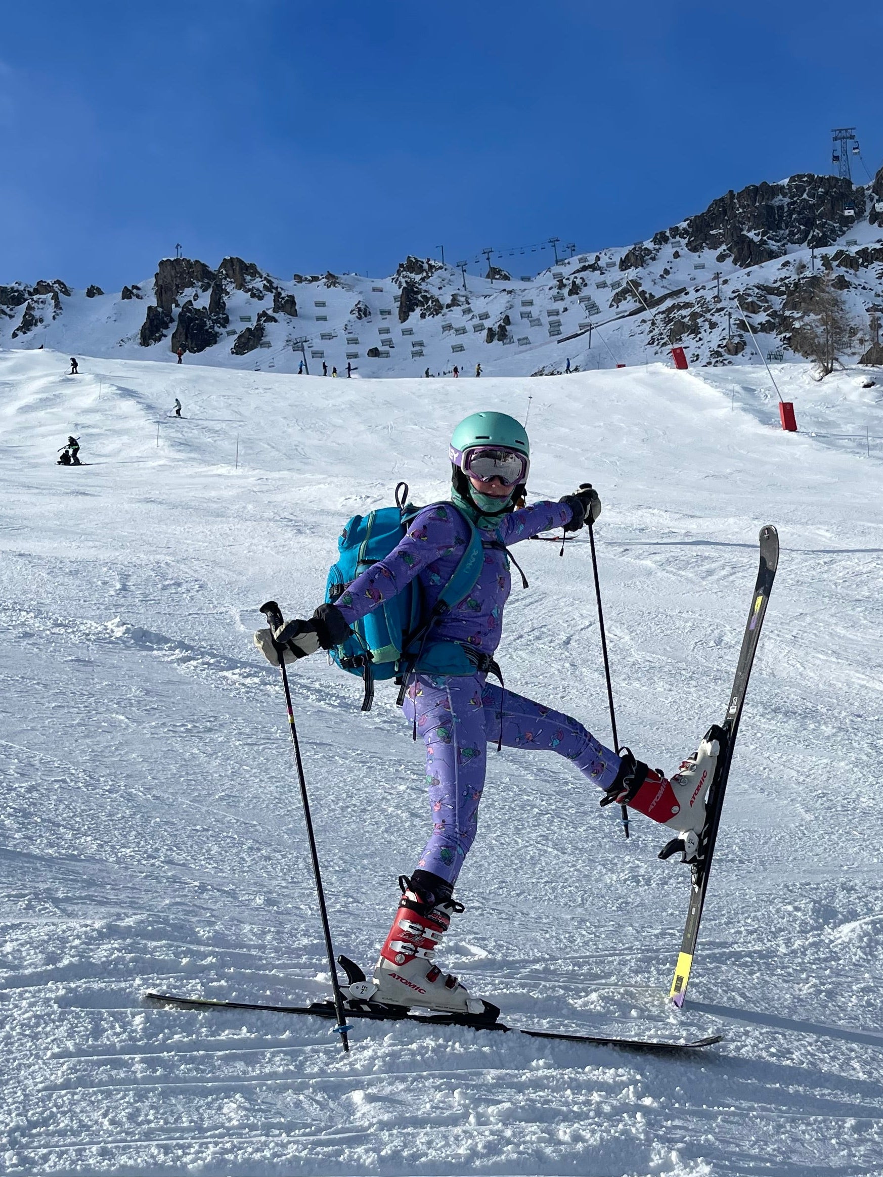 Person on ski slope with a clear blue sky